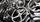 Close-up of finished three-spoke cast iron handwheels with polished rims, machined bores and handles fitted to several wheels.