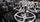 Three large machined and polished cast iron handwheels fitted with handles, with rows and stacks of smaller handwheels behind them.
