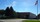 Exterior of ELCO Inc.’s manufacturing facility with a driveway, trees and an American flag flying beside the building.